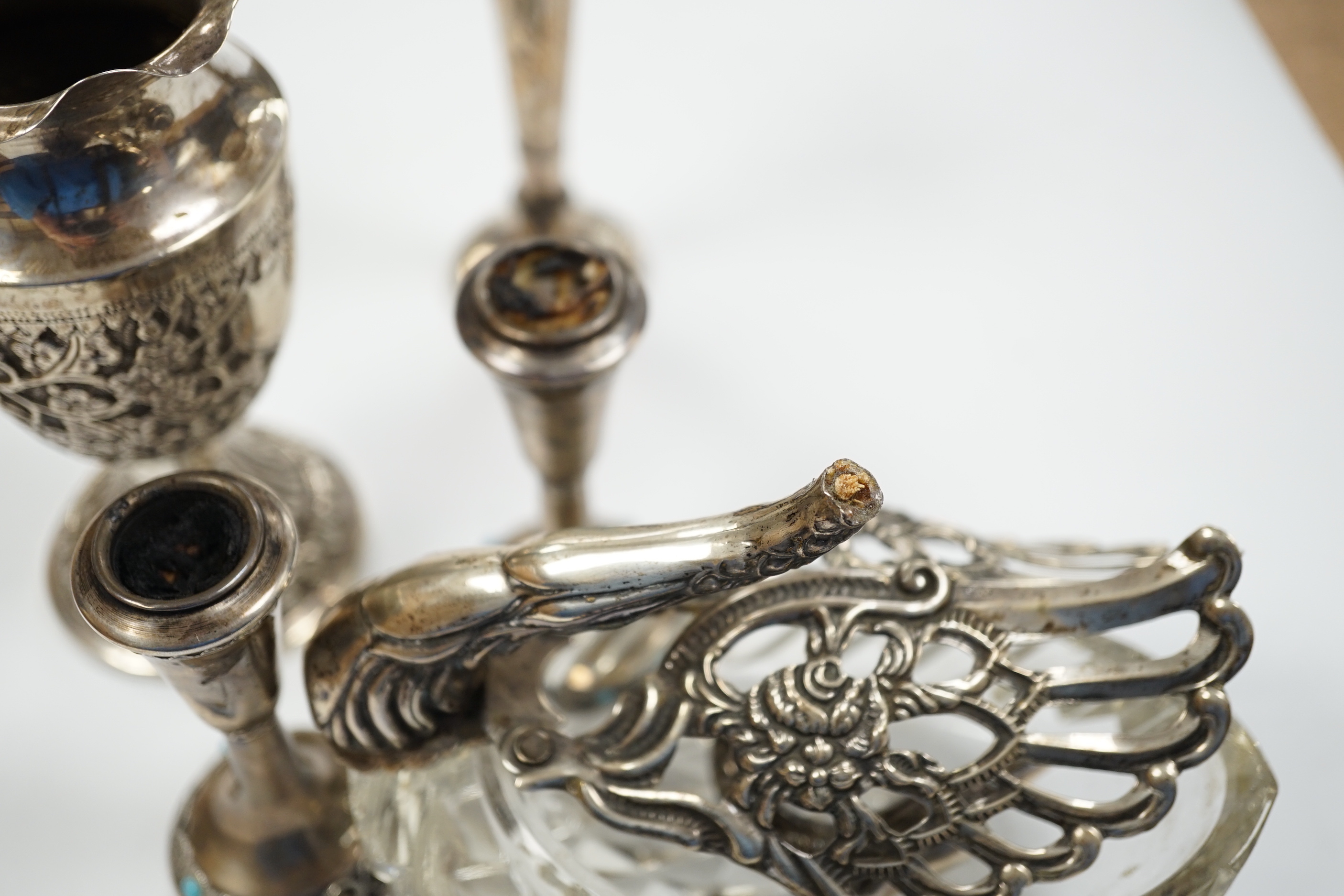 Two small white metal candlesticks, 8cm, an Indian vase, silver posy vase and a white metal mounted glass swan dish, a.f.